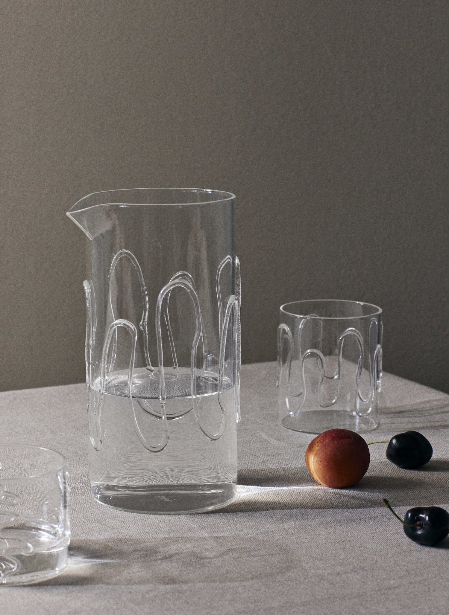 Doodle Carafe. An artful addition to any glassware collection. Made entirely from durable borosilicate glass, its distinctive, wavy patterns are crafted by an experienced glass master using a torch, ensuring that no two pieces are identical. 