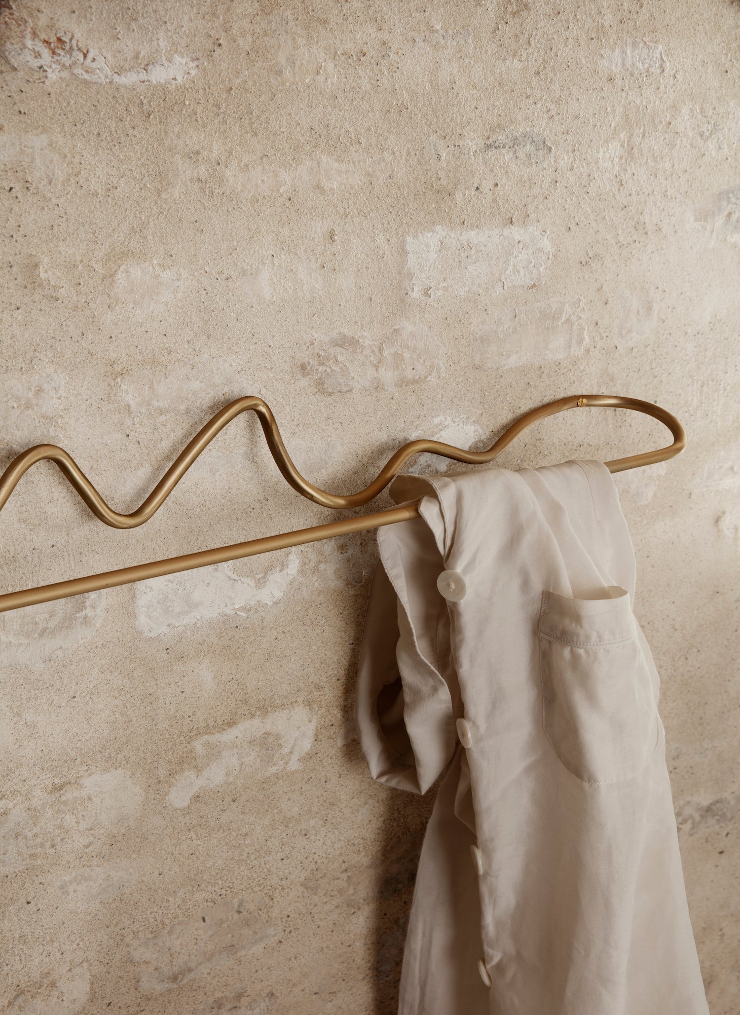 Curvature Towel Hanger. Organically shaped hardware for the bathroom hand formed in pure, solid brass with a matte finish.
