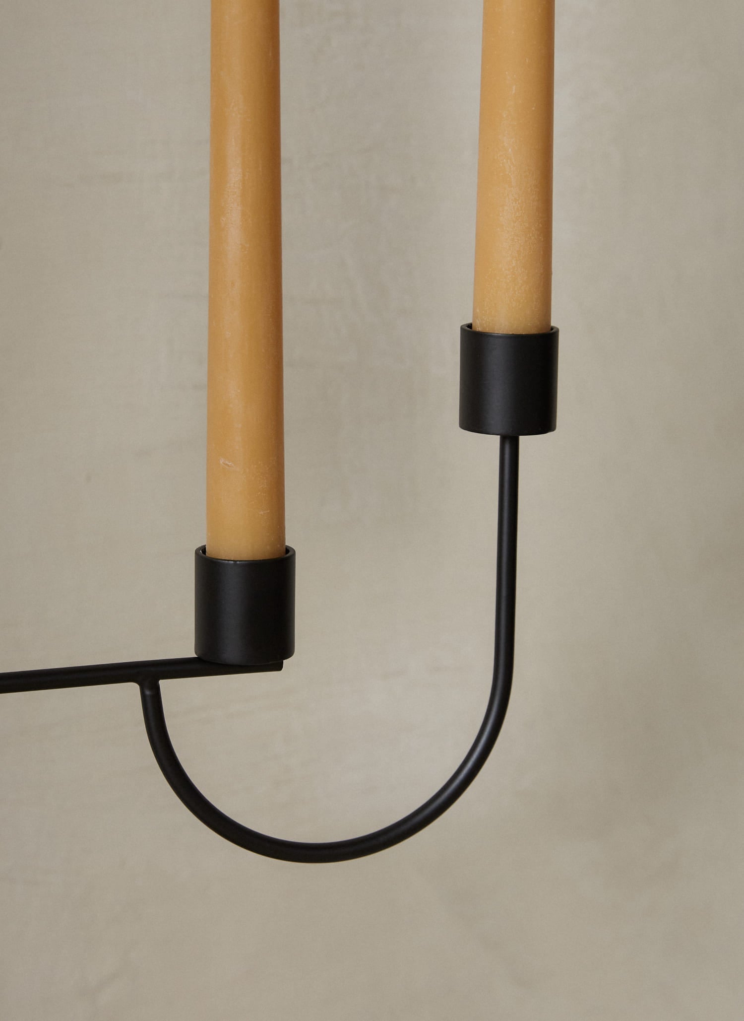 Avant Candelabra. An expression of balance, this modern, geometric candelabra features a voluminous cone base and three candle holders in black powder coated metal with a smooth finish. 