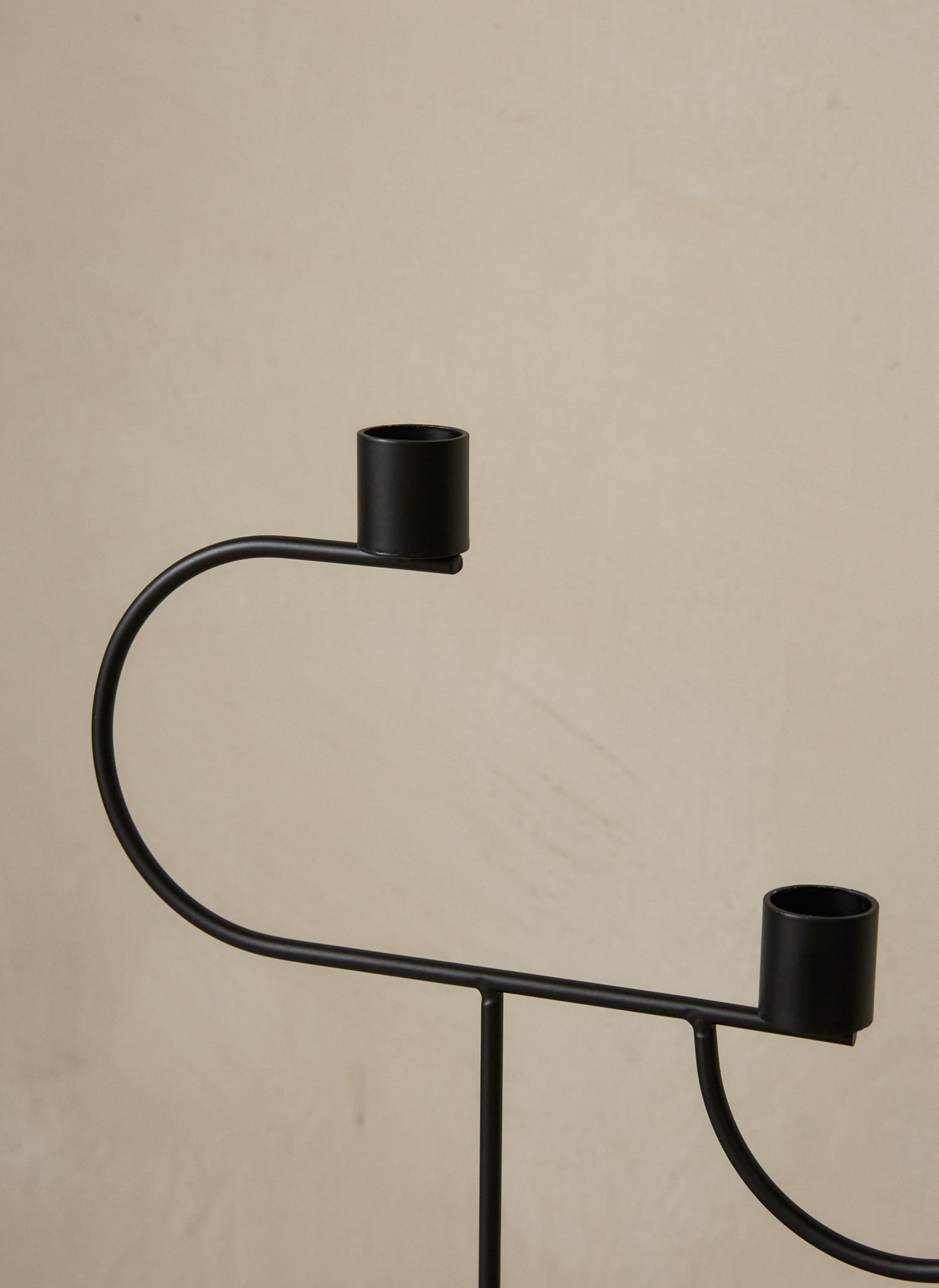Avant Candelabra. An expression of balance, this modern, geometric candelabra features a voluminous cone base and three candle holders in black powder coated metal with a smooth finish. 