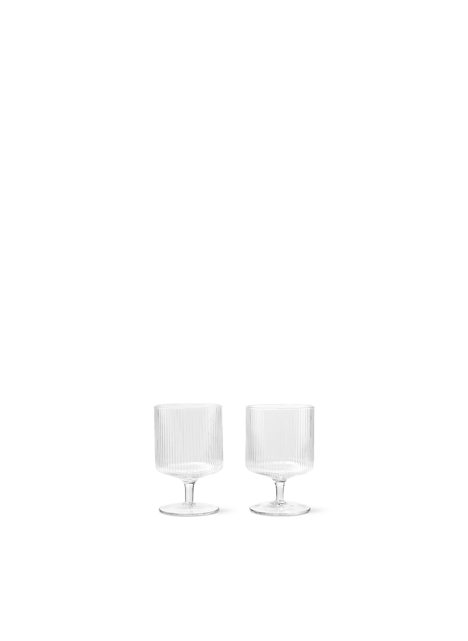 Mouth-blown wine glasses featuring a rippled surface and geometric silhouette, making the set of two glasses stackable.