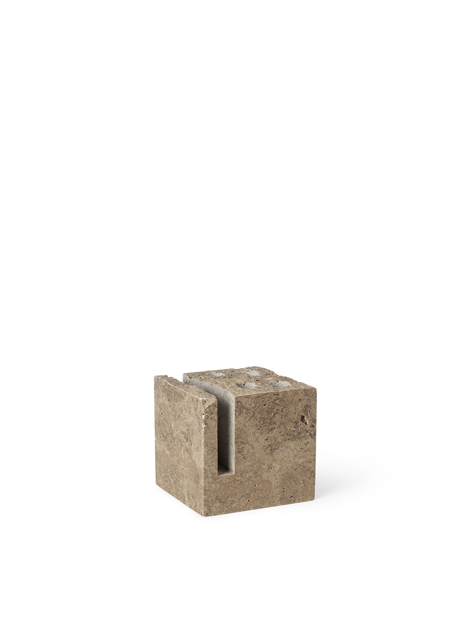 Klint Pencil Holder. An elevated, sculptural pencil holder made entirely from travertine stone with a rough, unpolished surface.