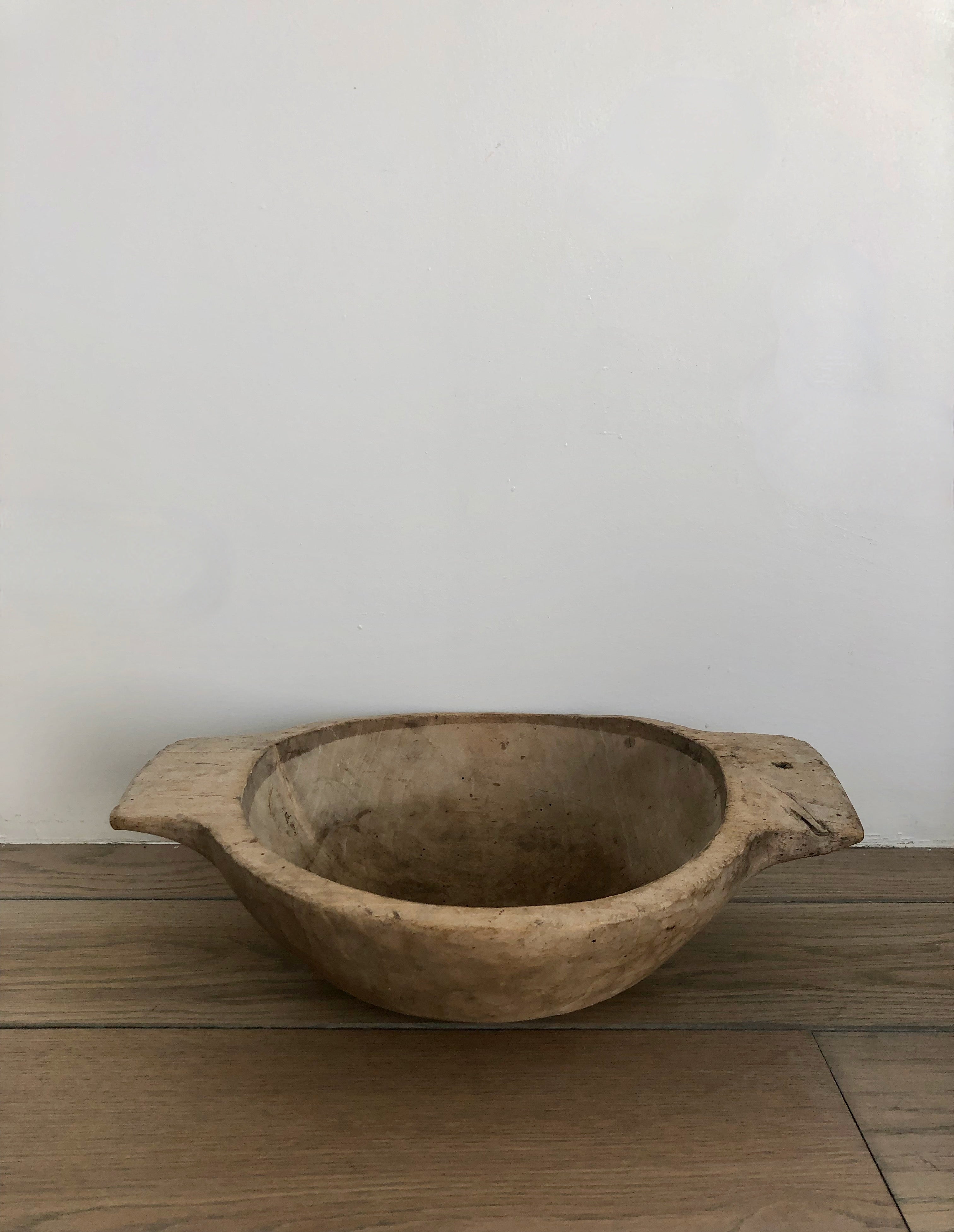 Vintage French trencher bowl with round shallow base and  handles at sides.