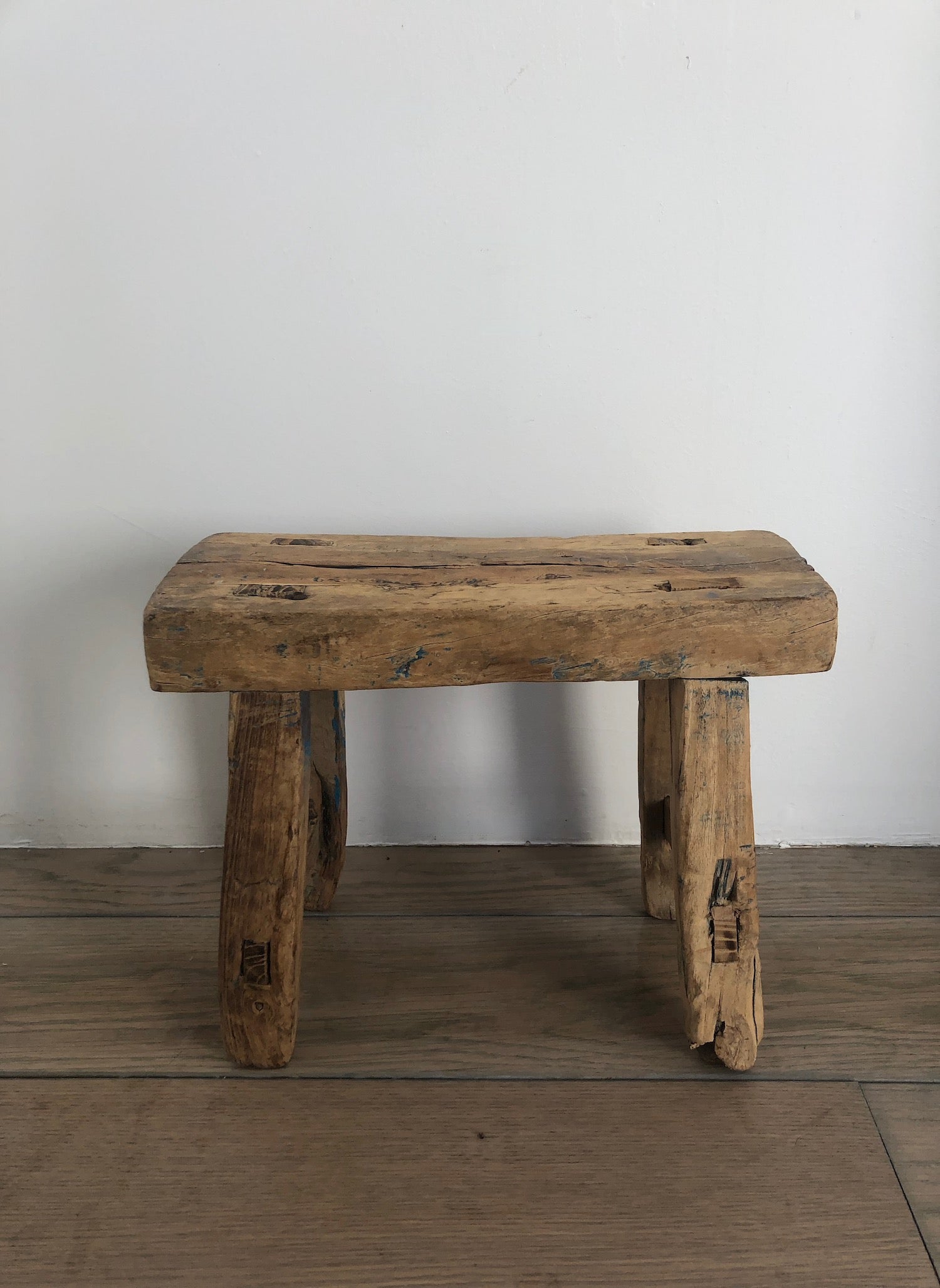 Vintage French accent stool with traces of blue pigment indicative of history and loving wear.