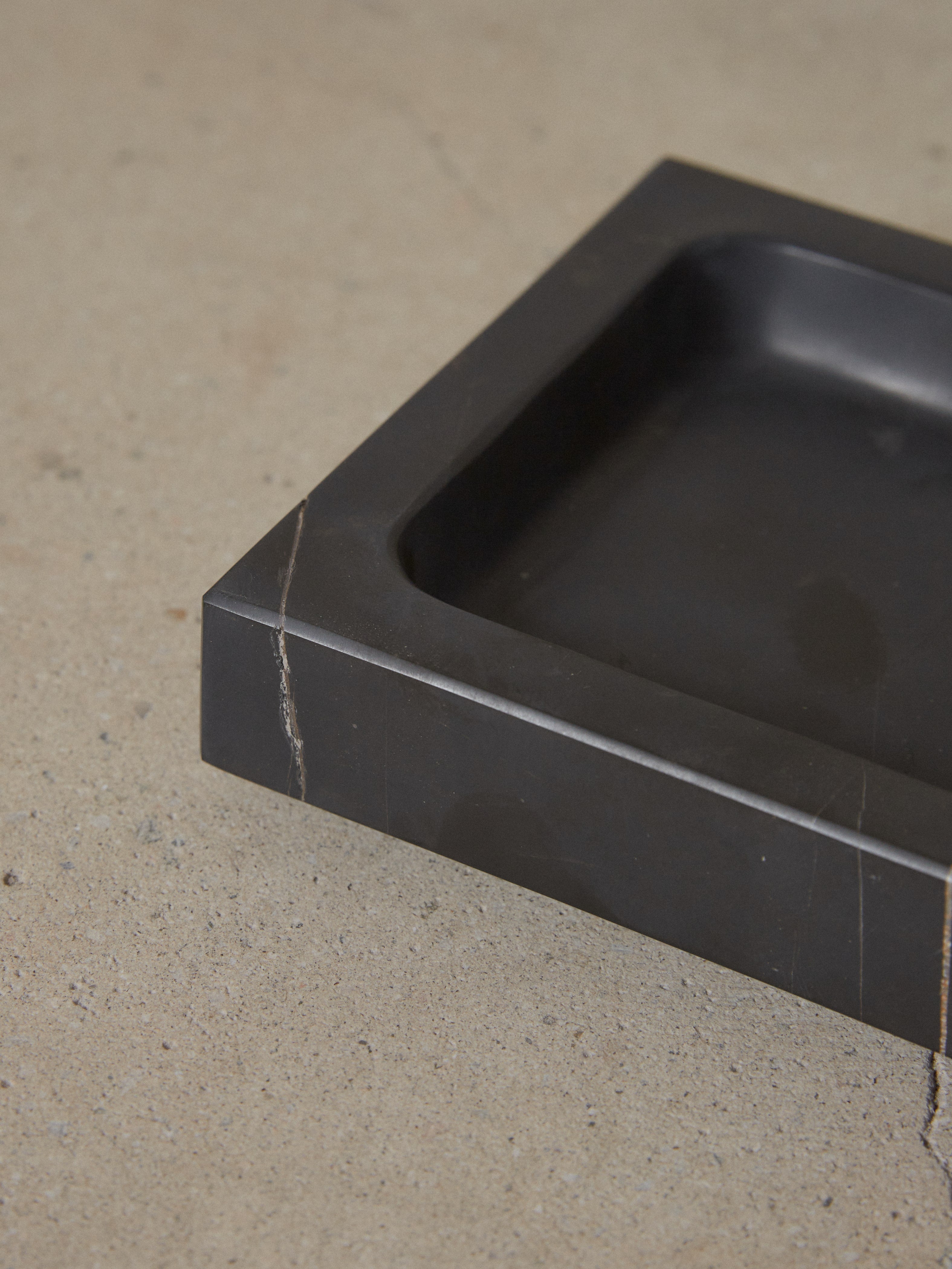 Tray interior carved from a single piece of black marble.