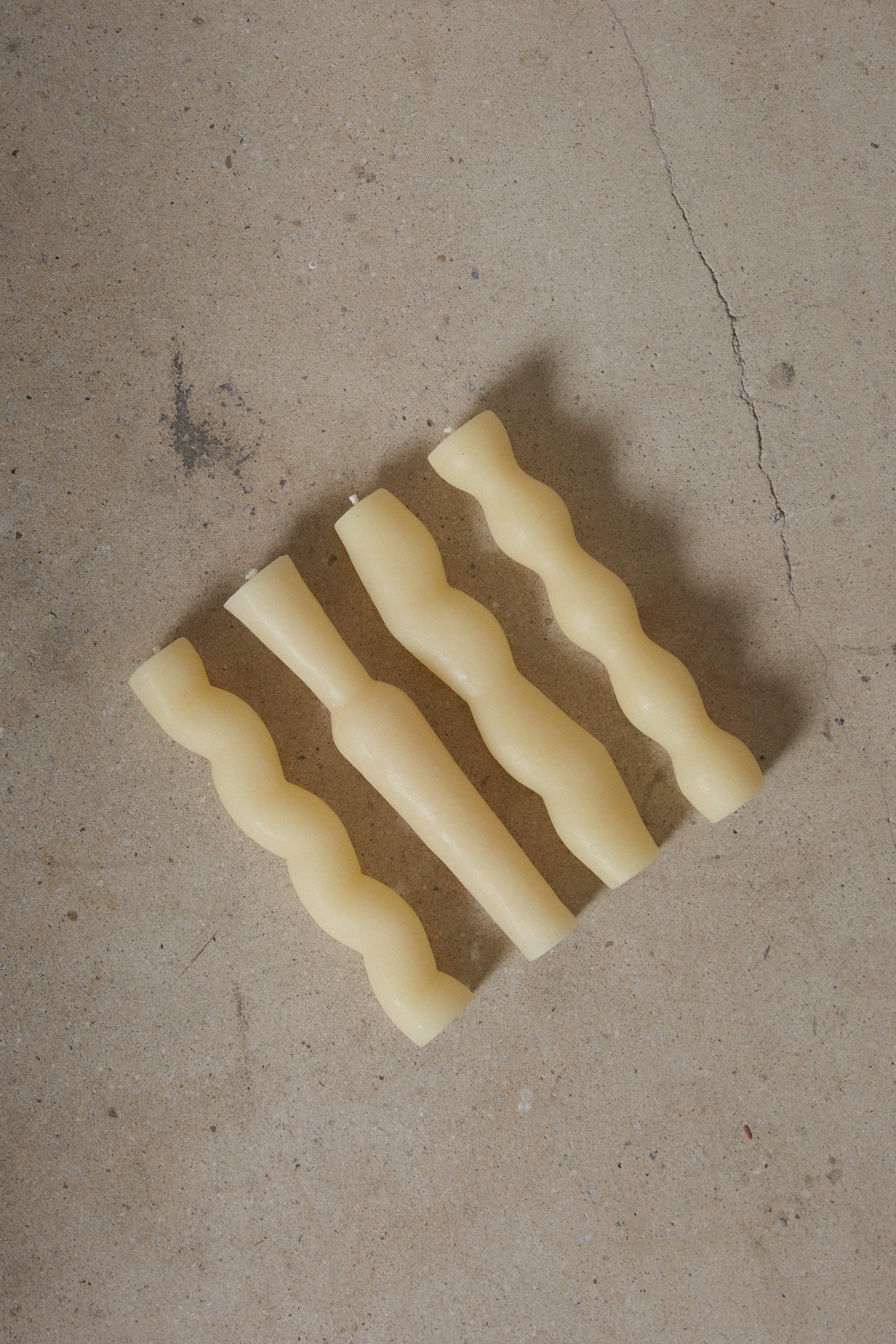Set of four sculptural, hand carved column taper candles inspired by nature and made of 100% pure beeswax from local family-run bee farms artfully packaged in a gift box. 