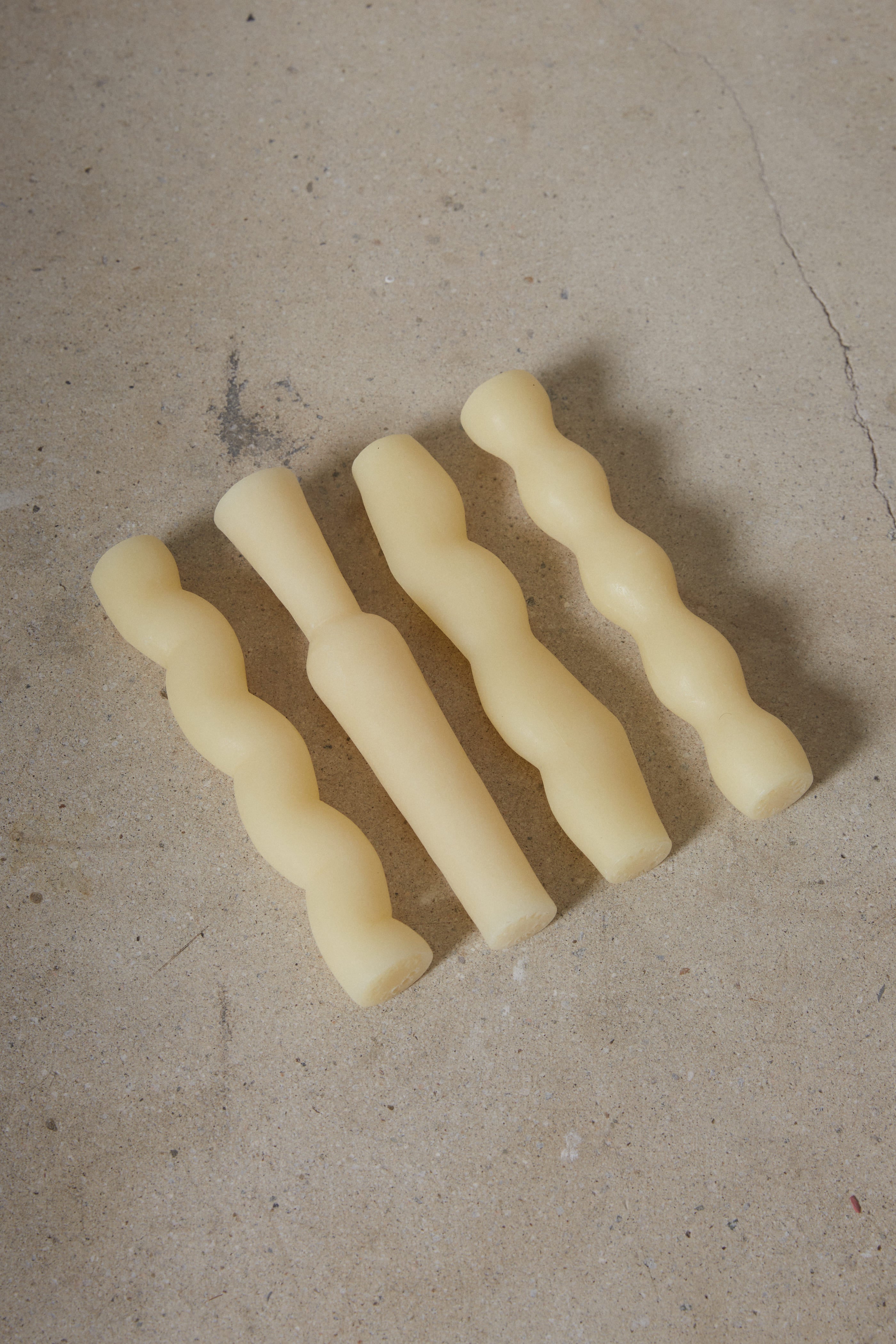 Set of four sculptural, hand carved column taper candles inspired by nature and made of 100% pure beeswax from local family-run bee farms artfully packaged in a gift box. 