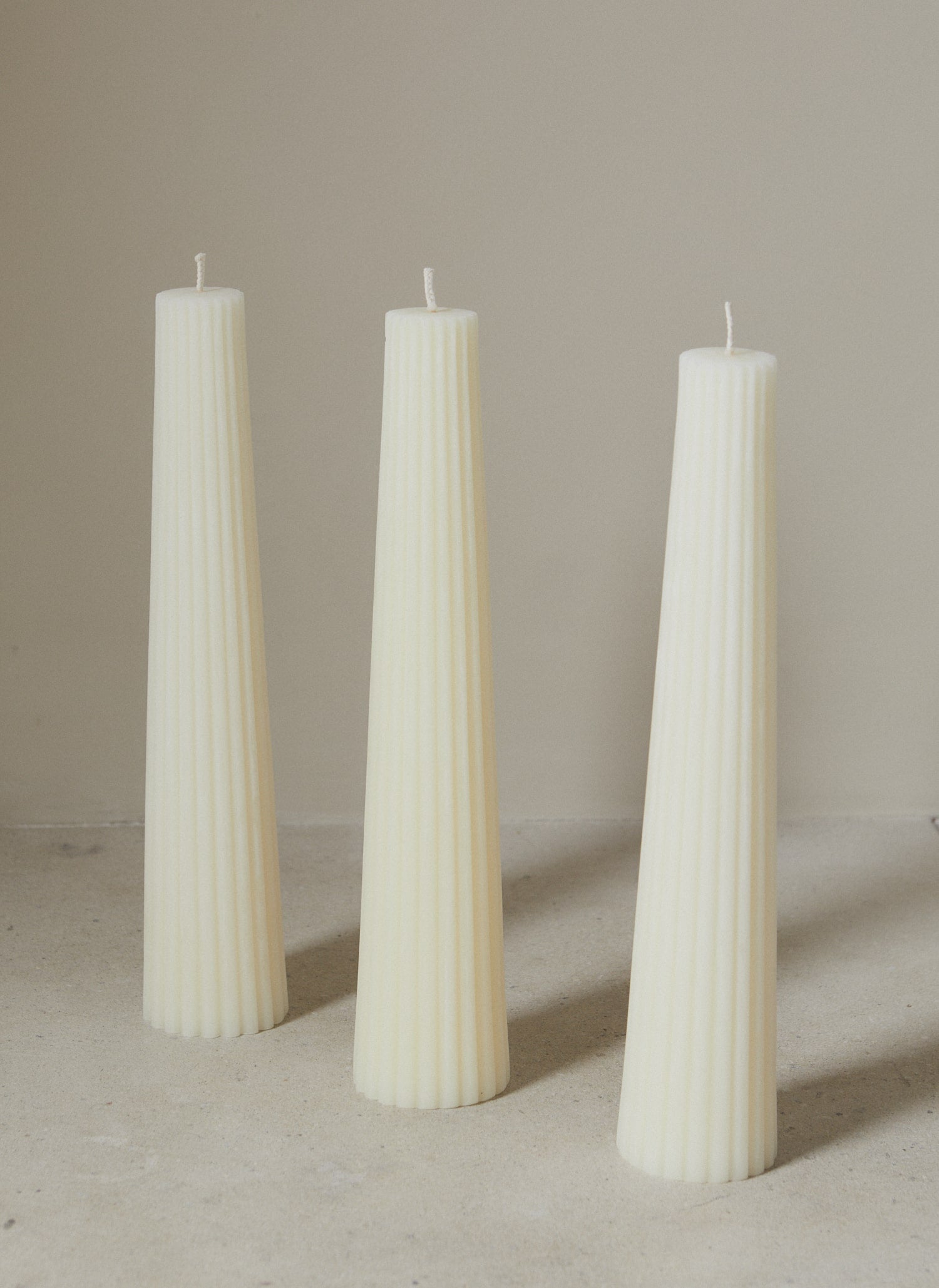 Statement textured tapered pillar candle made from 100% American Beeswax in cream.