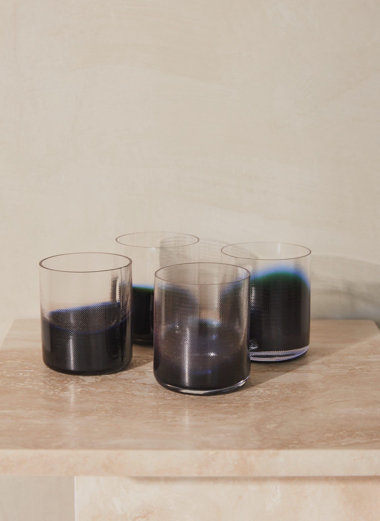 Raw Glass Set. Set of four tumbler glasses mouth blown into raw woven molds, textured and shaped by soft textile copper and accented with a blue gradient color. 