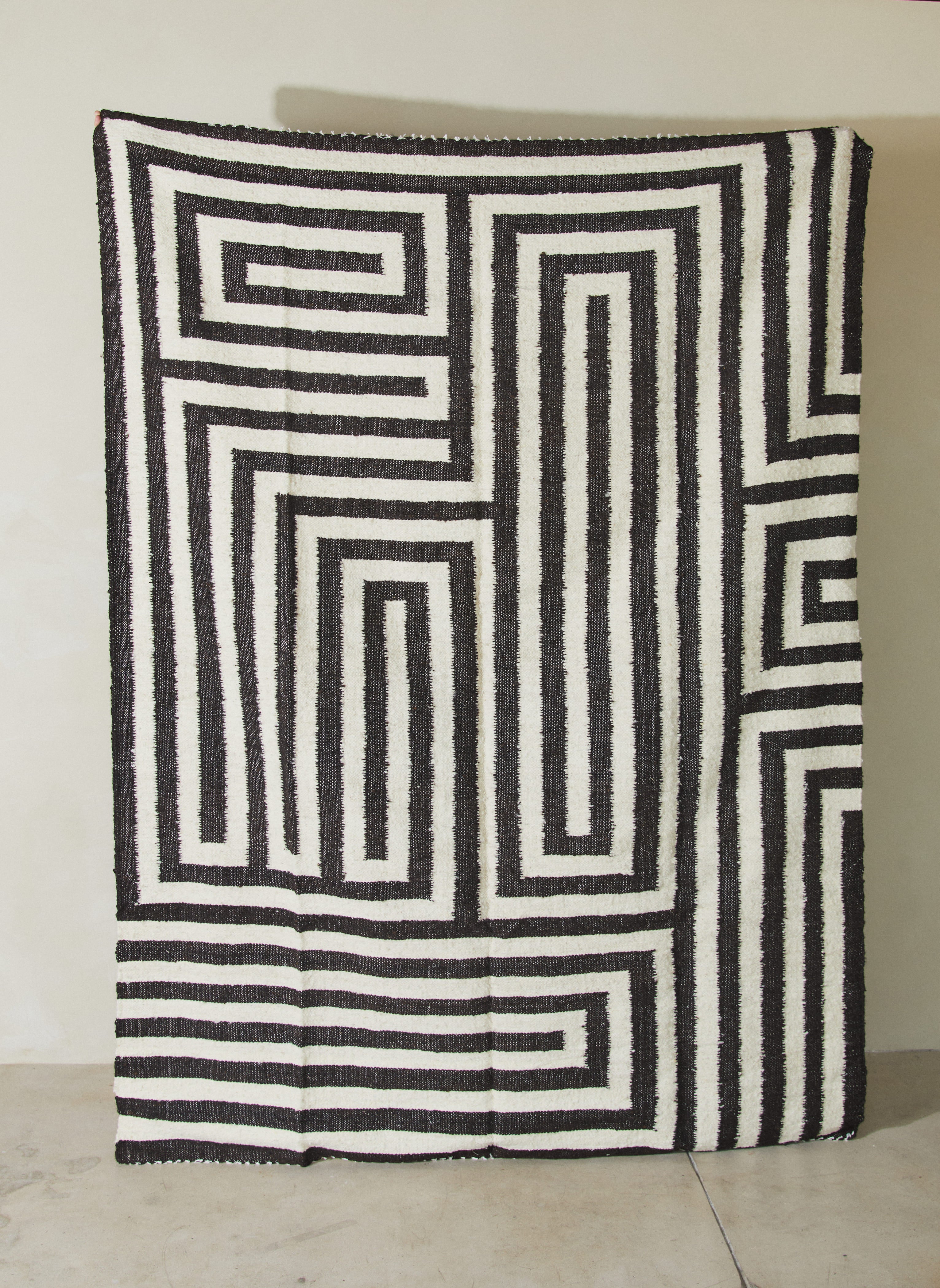 Laberinto Black. Rare find. Large, geometric area rug made of 100% hand-spun sheep wool with an abstract design reminiscent of a labyrinth. 