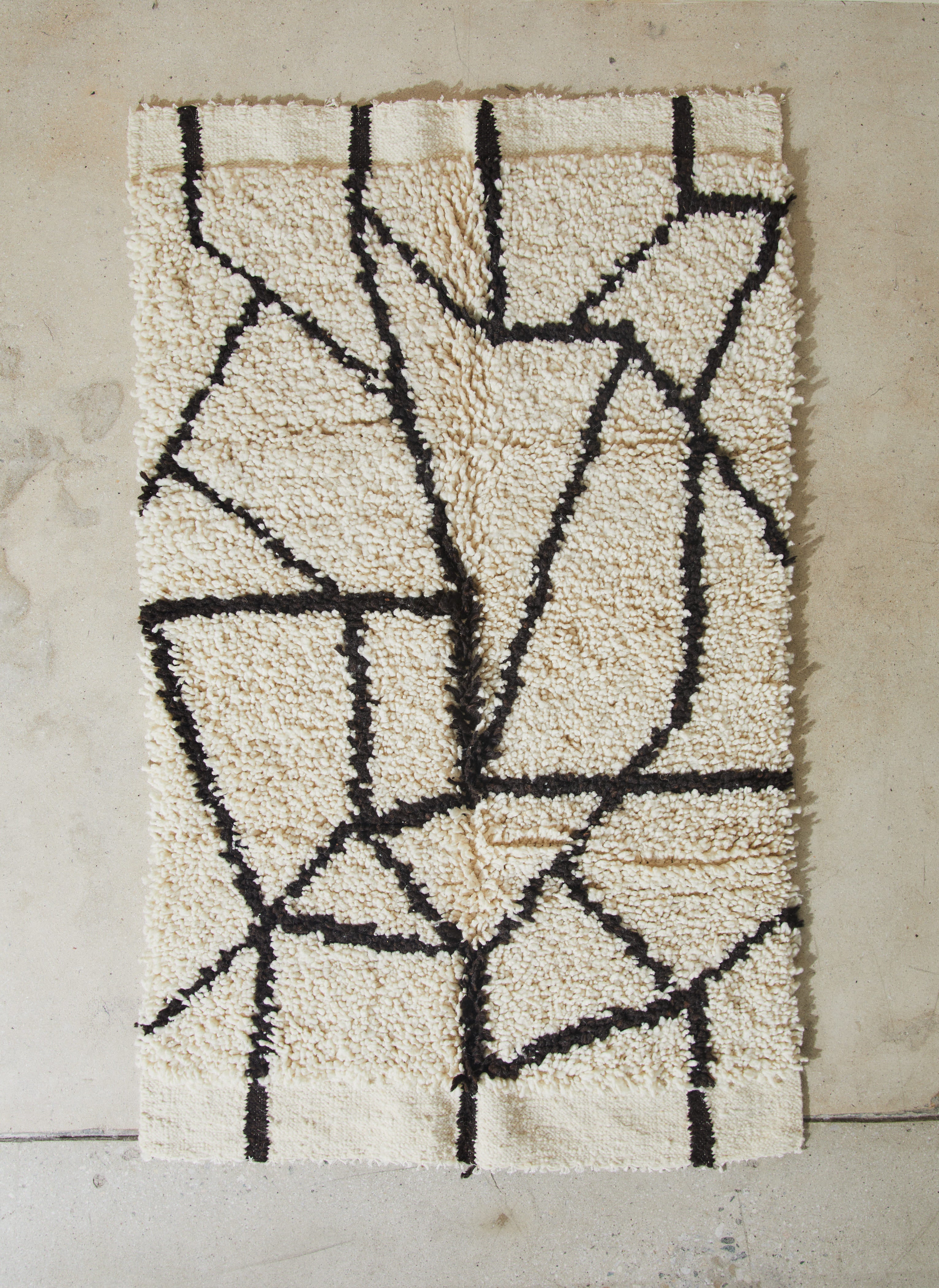 Pelu Stone. Rare find. Textured area rug made of 100% hand-knotted sheep wool with a flat weave edge and abstract design symbolizing the ability to be grounded and connected with the earth.  