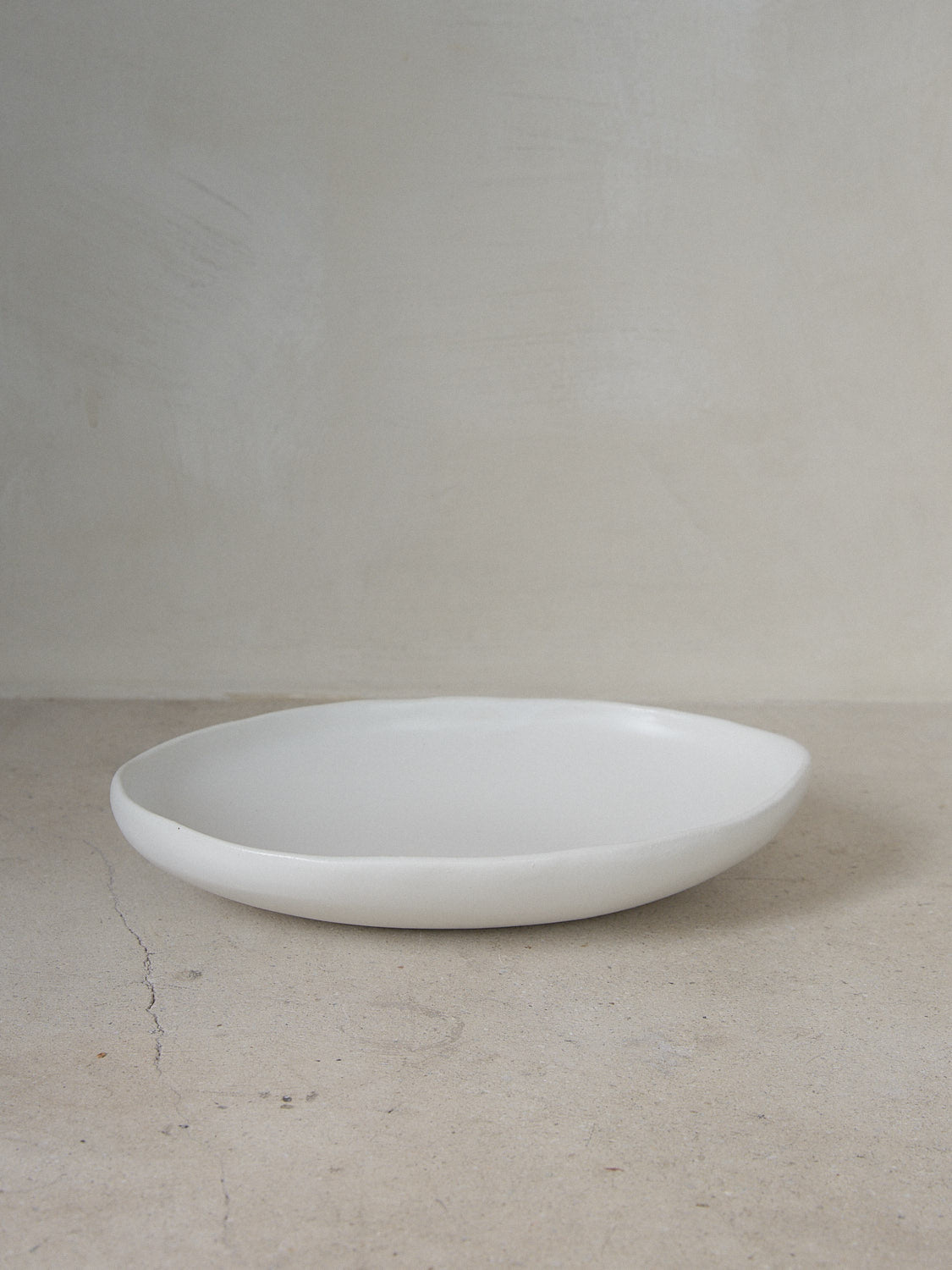 Raw Oval Bowl in Ecru. Large, oblong handmade serving bowl perfect for entertaining and everyday use in classic matte white stoneware. 