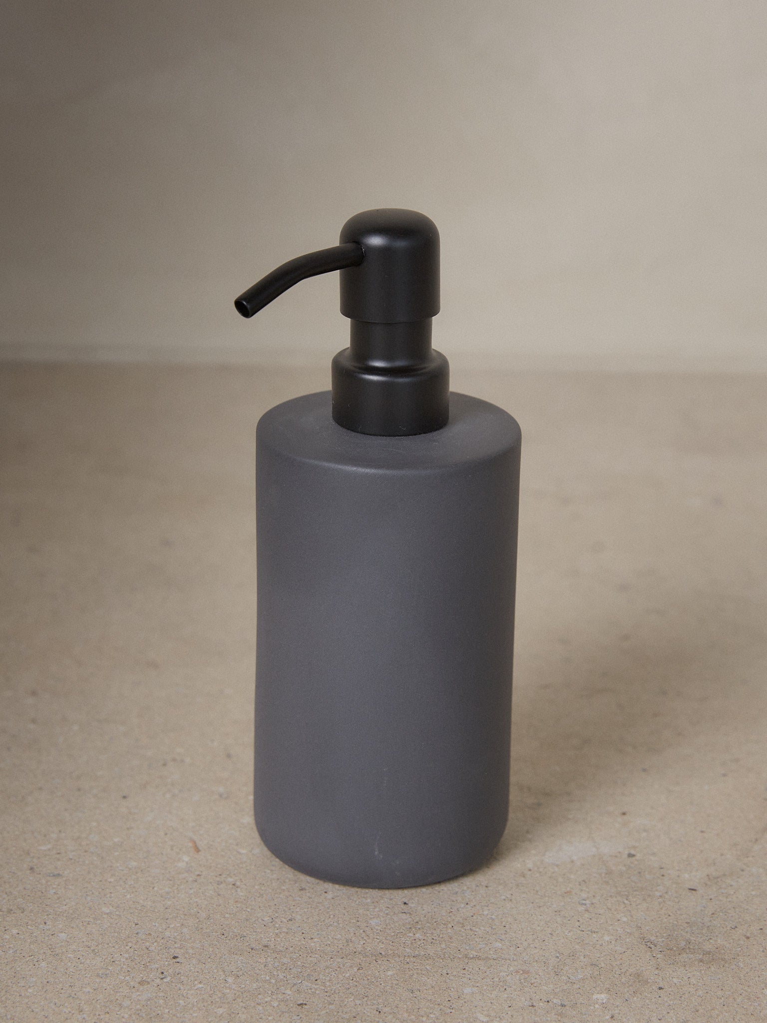 Dark Grey Cose Soap Dispenser. A study in refined simplicity, the Cose Soap Dispenser by Bertrand Lejoly for Serax adds subtle luxury to any bathroom or kitchen. 