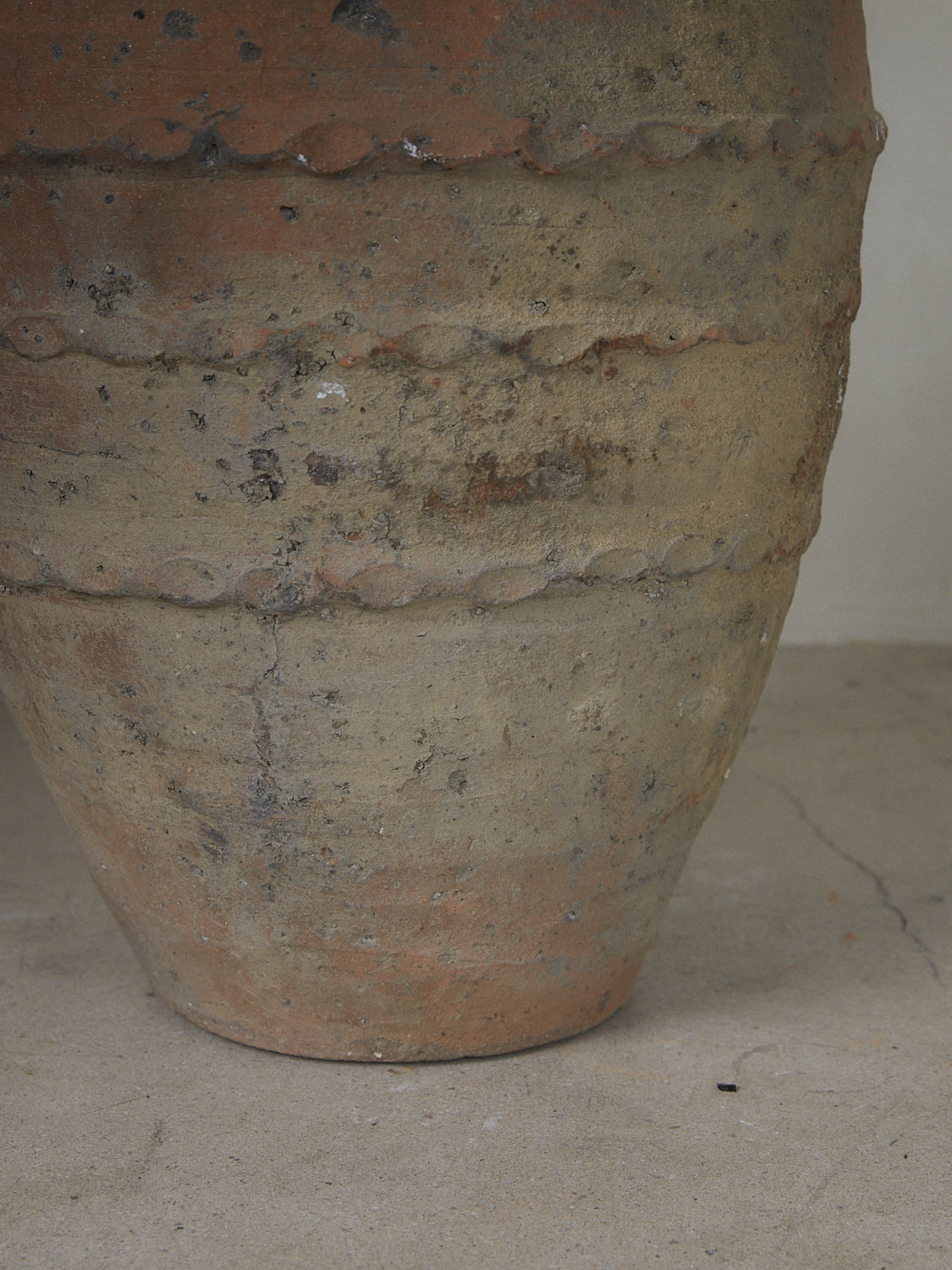 Authentic terracotta vintage vessel originally purposed for storing olive oil with banded braiding details throughout. 