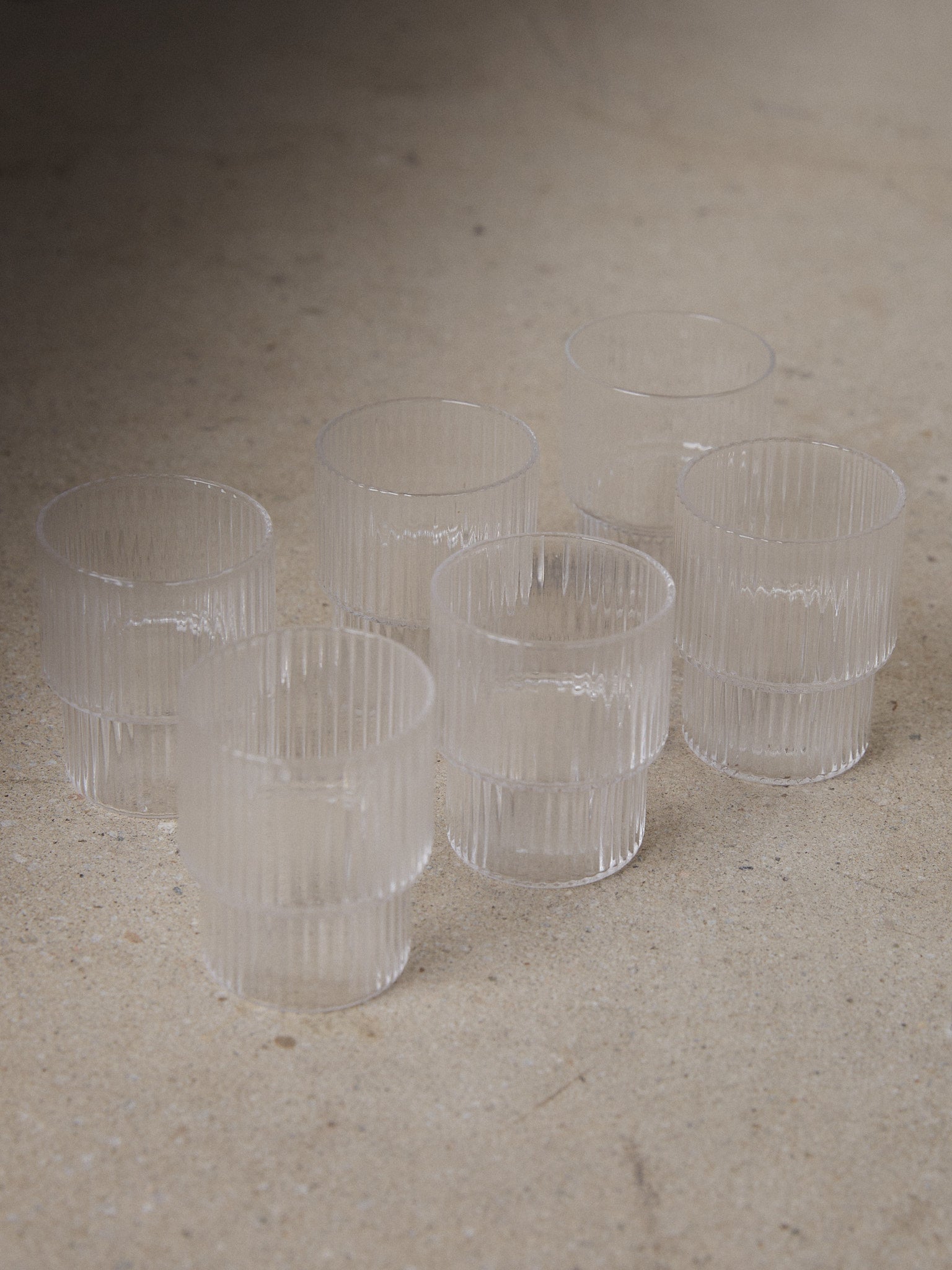 Ridge Shot Glass Set/6. A set of six unique shot glasses with geometric forms and a sophisticated vertical ridge surface in clear transparent glass