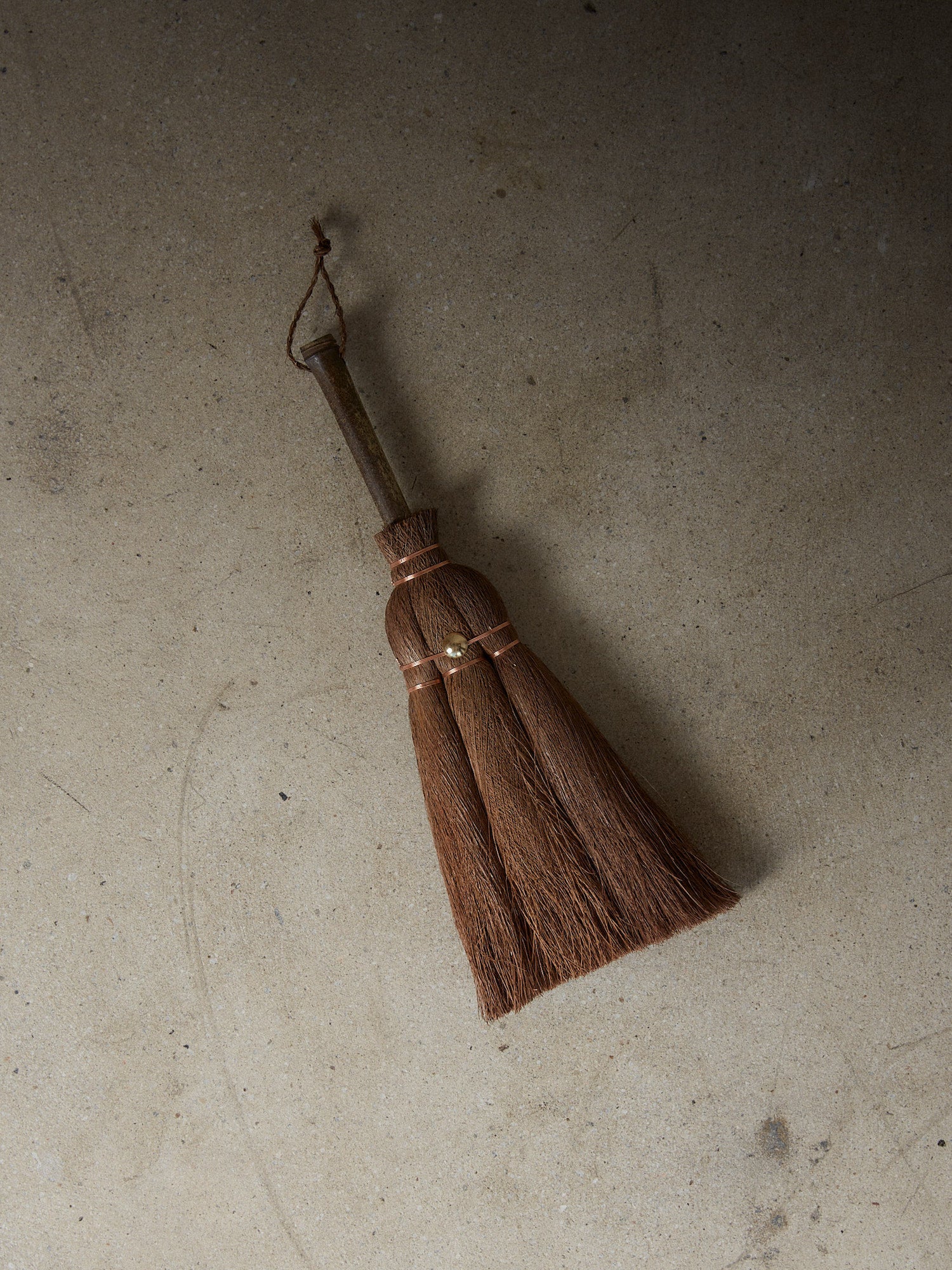 Vintage Hand Broom. Rare find. Natural hand held broom with a short bamboo handle hand crafted of fine Indian Palm fibers and joined by copper wire for a light, clean sweep. Includes woven loop for hanging.