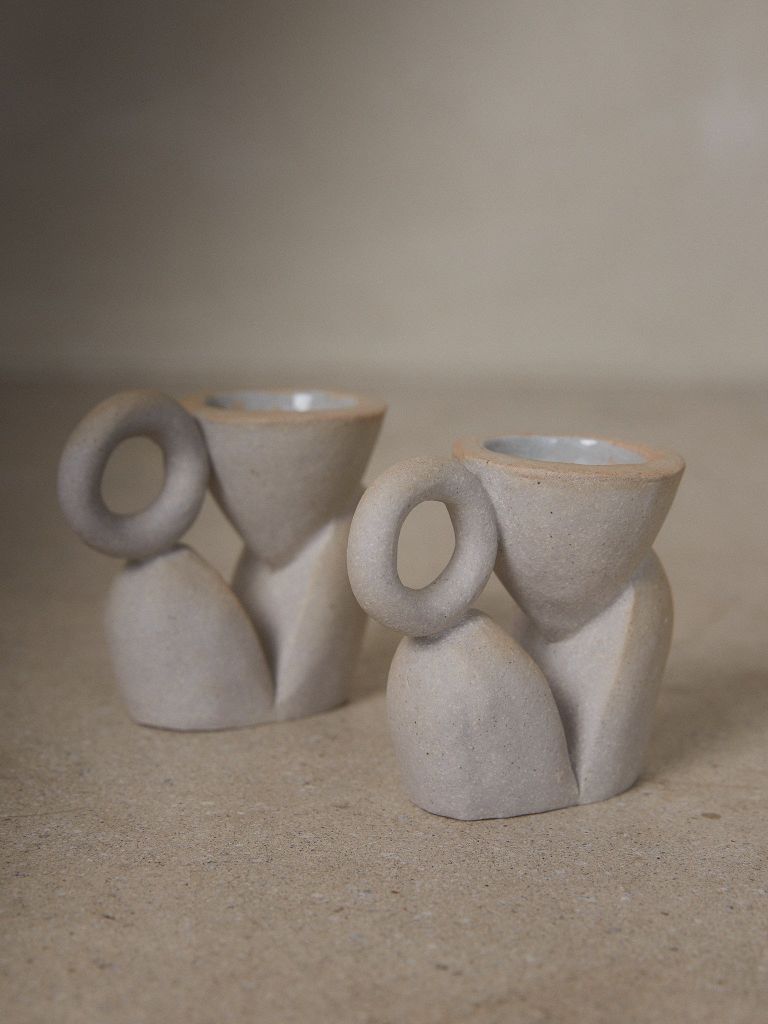 Bloom Candle Holder Pair. Sculptural abstract candleholders inspired by nature in natural grey ceramic stoneware. 