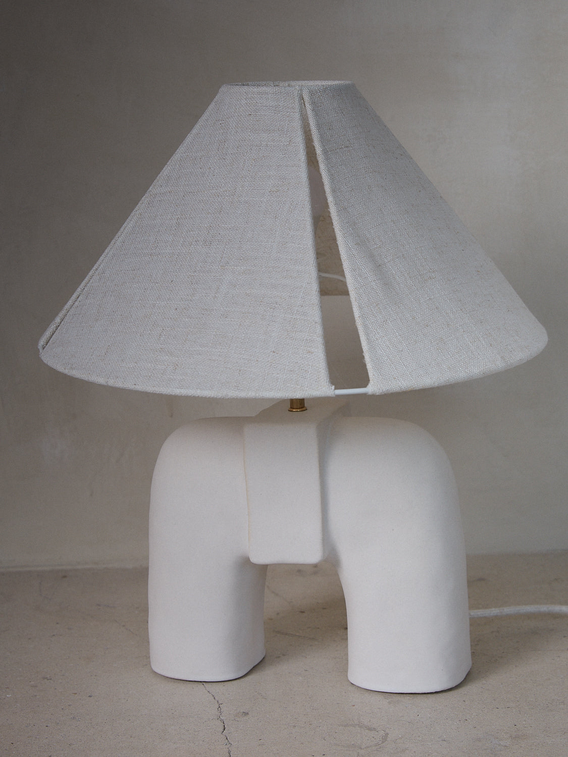 Handcrafted ceramic Audrey Table Lamp by Cuit Studio with linen lampshade in white.