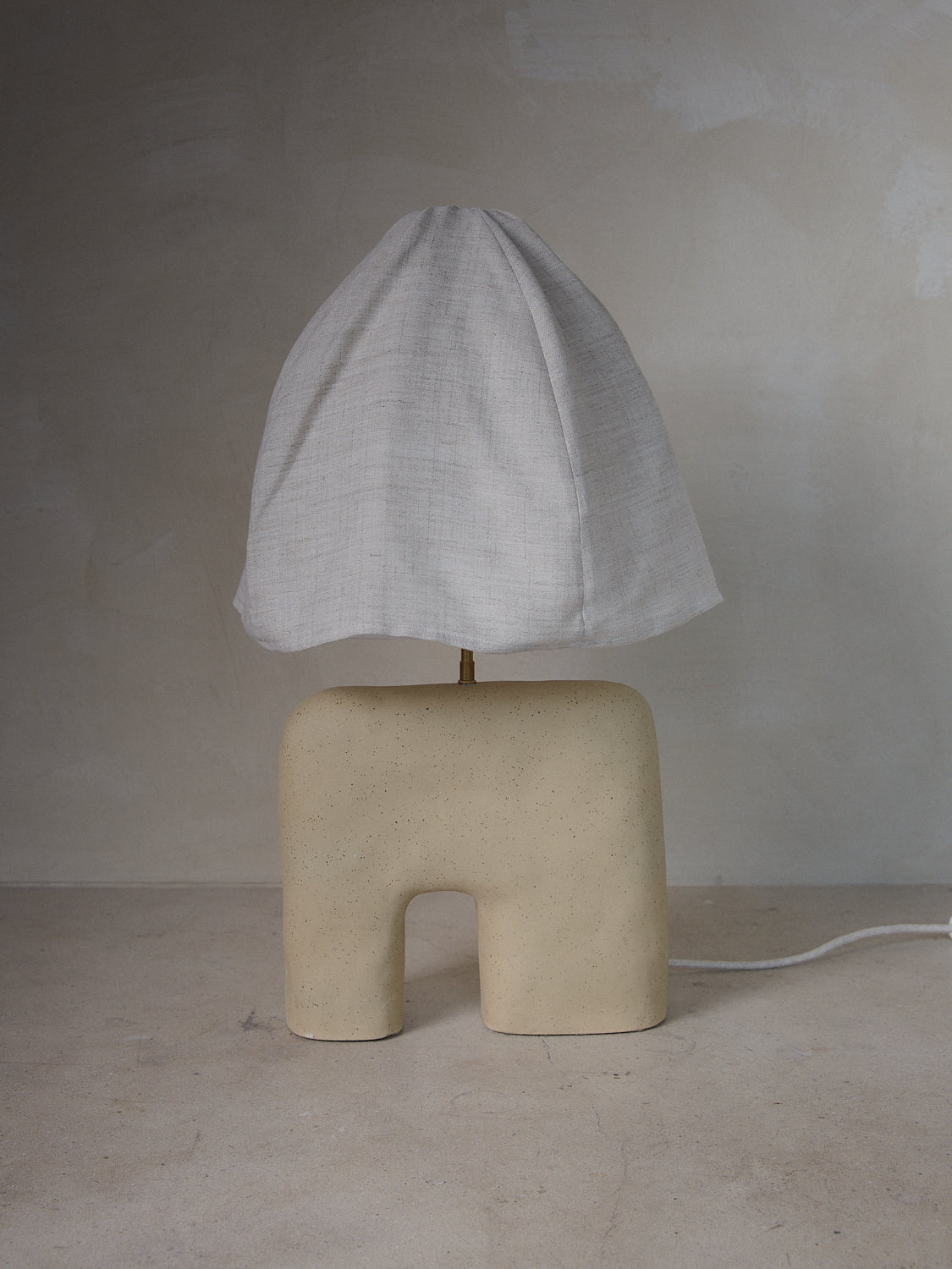 Handcrafted ceramic Aurore Lamp from Cuit Studio with linen shade.