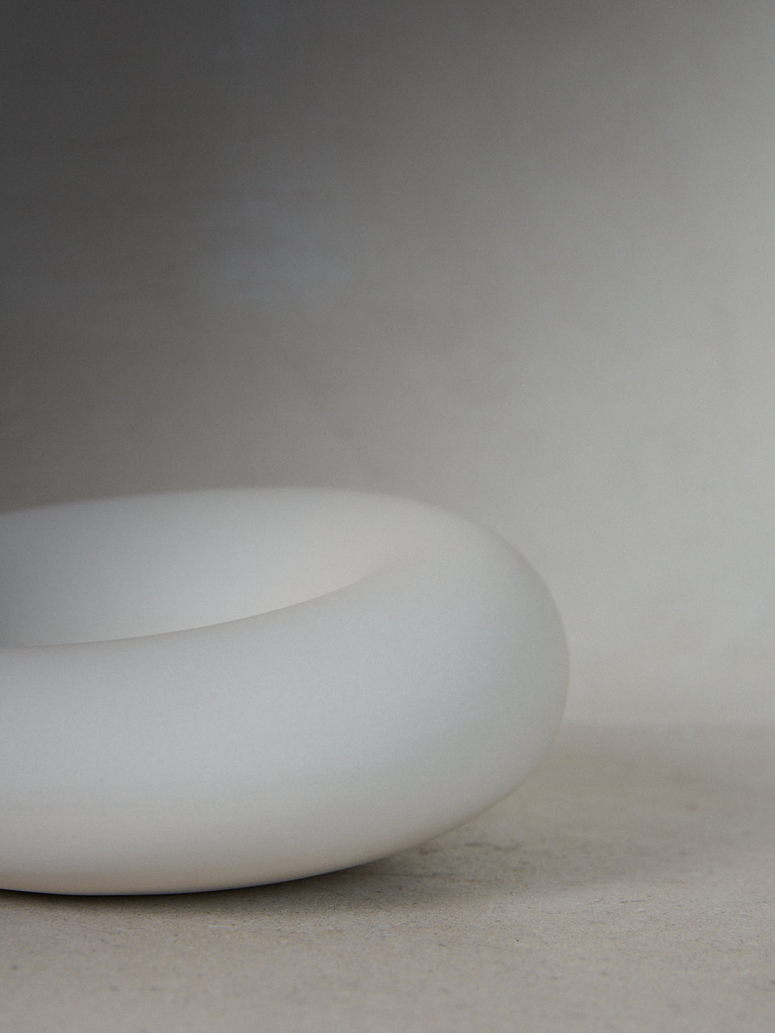 Holding Form. A decorative sculptural object embodying closeness and comfort in matte white..