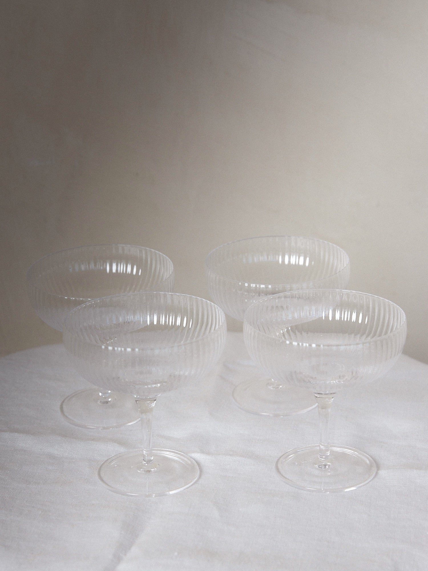 Champagne Coupe Set/4. Unique find. Special edition set of ribbed champagne glasses designed by famed Michelin star chef and restauranteur, Sergio Herman, featuring delicate, tender folds fading to the edge of the glass. 