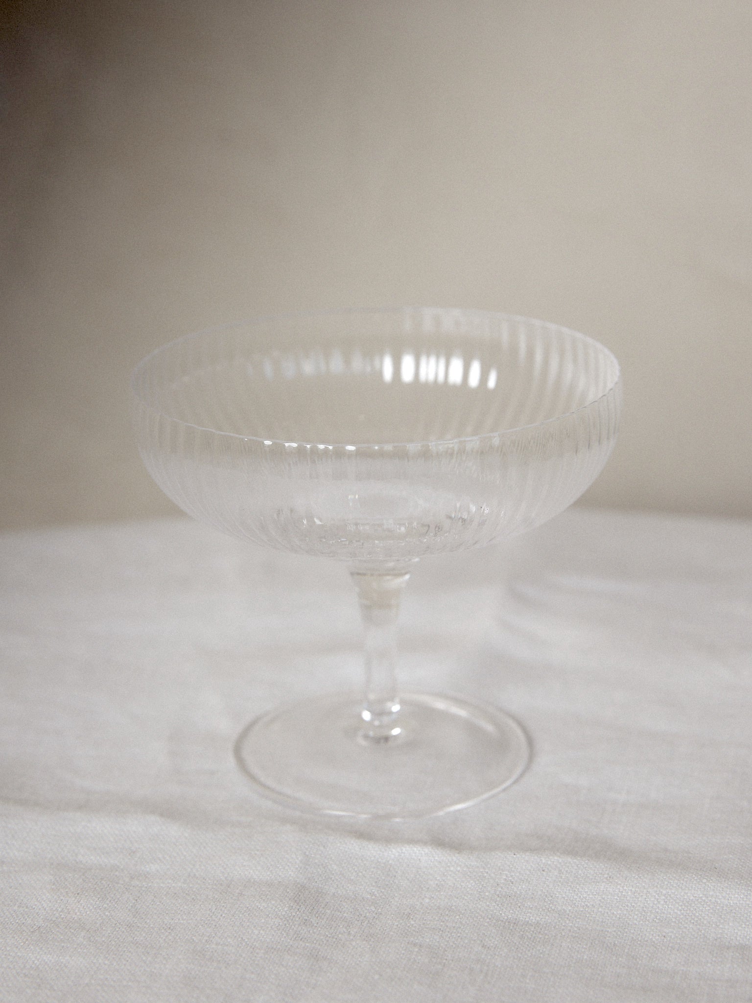 Champagne Coupe Set/4. Unique find. Special edition set of ribbed champagne glasses designed by famed Michelin star chef and restauranteur, Sergio Herman, featuring delicate, tender folds fading to the edge of the glass. 