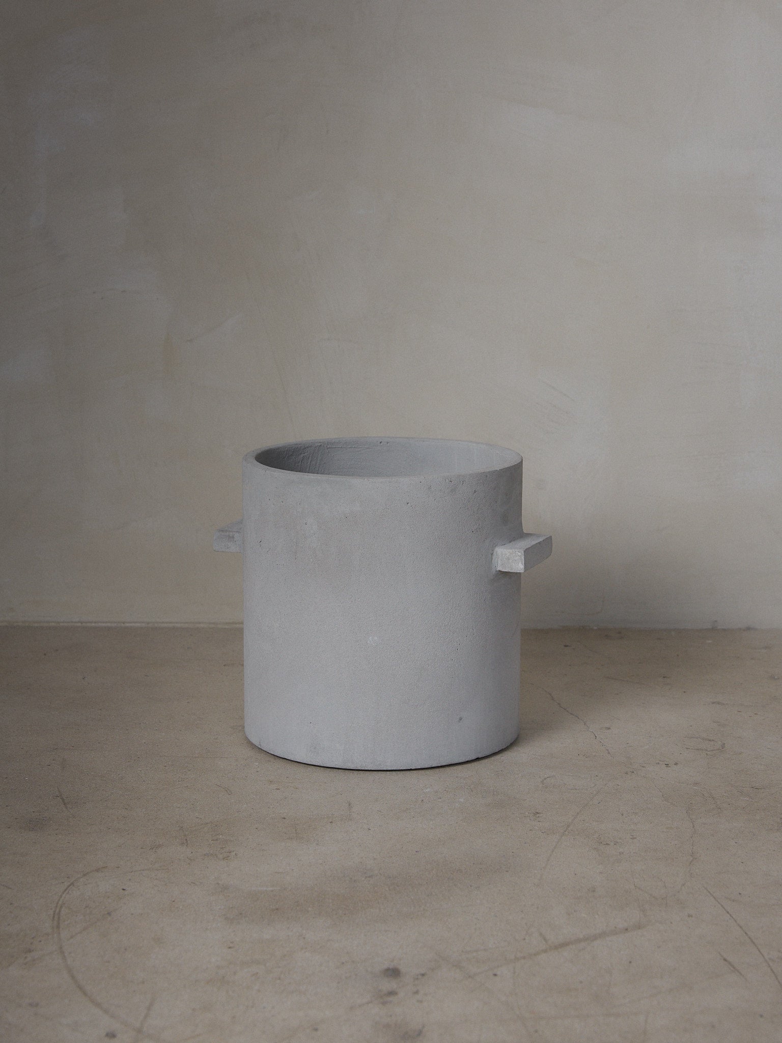 XL Concrete Flowerpot. A sculptural, minimalist planter pot with looped handles, a linear structure and otherworldly vibe. 