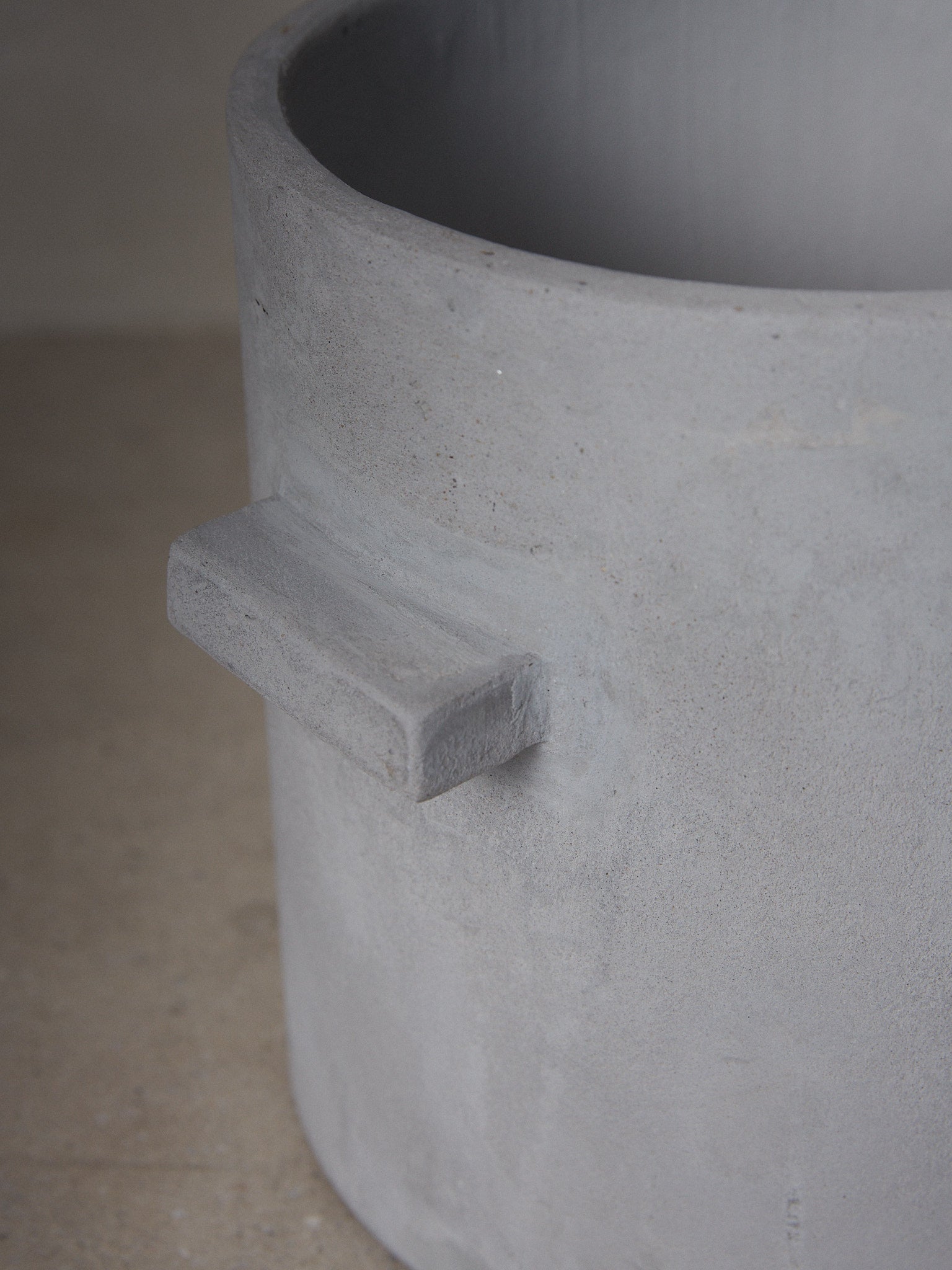 XL Concrete Flowerpot. A sculptural, minimalist planter pot with looped handles, a linear structure and otherworldly vibe. 