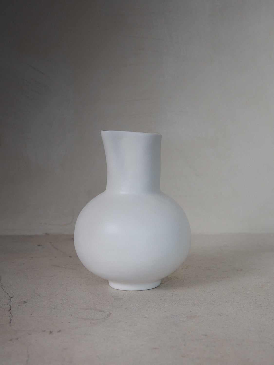 Water Pitcher. Footed stoneware jug with wide, rounded bodice and narrow, spouted neck 