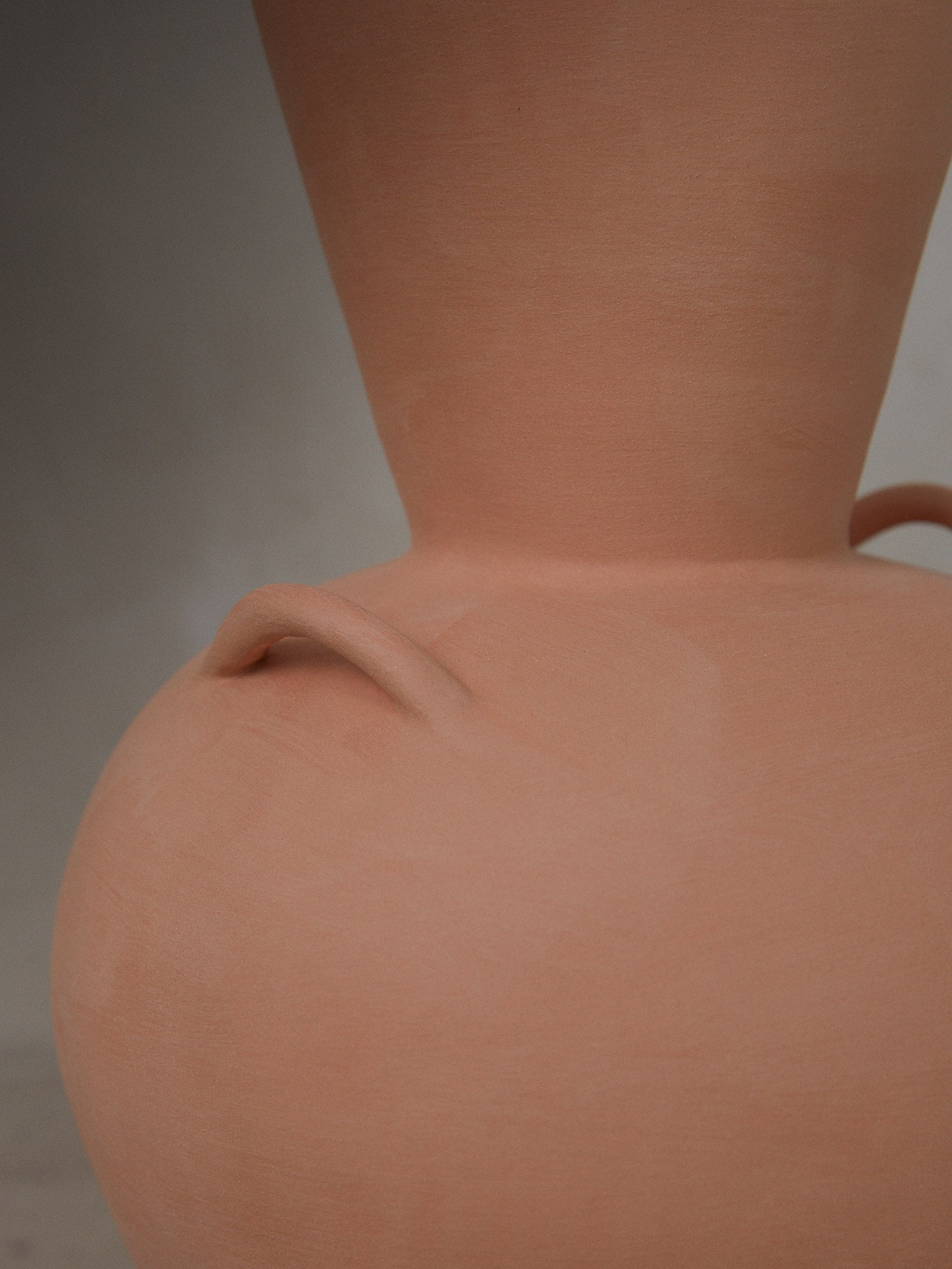 Terracotta Vase. Handmade terracotta vase with low, rounded bodice, stately neck and decorative side handles created with a modeling technique featuring traces of the artistic process.