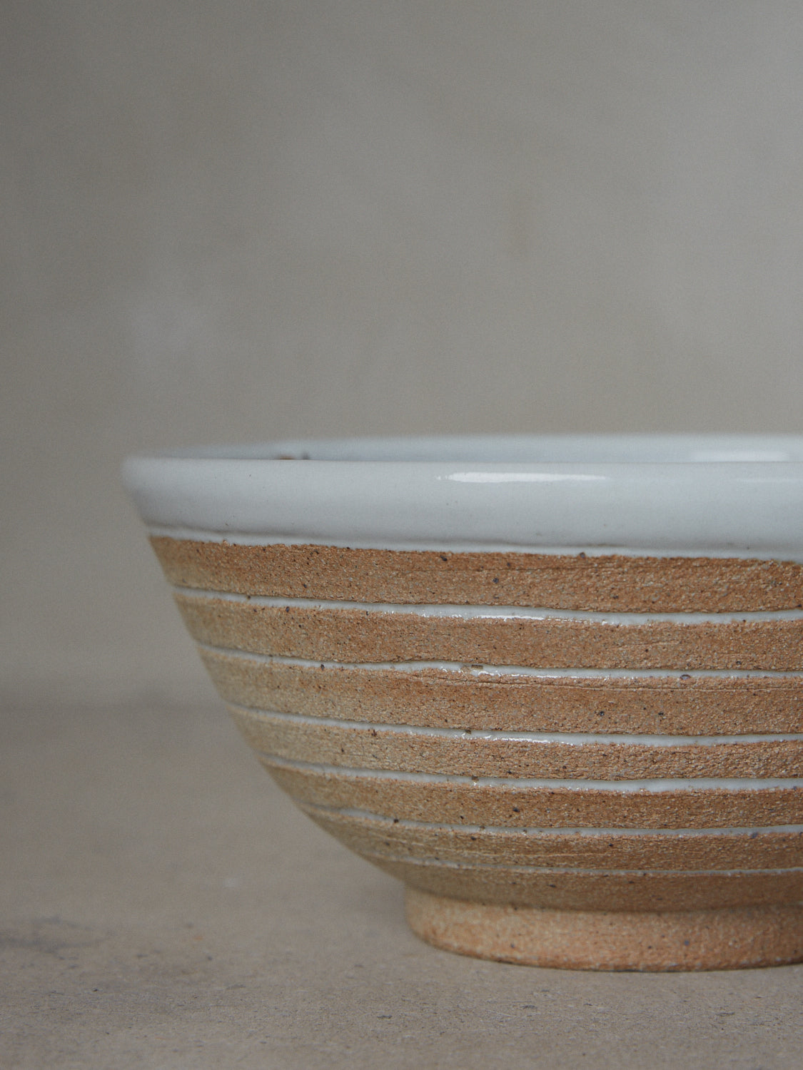Stone Shinogi Bowl. Limited edition. One-of-a-kind, hand-thrown, footed stoneware bowl with horizontal Japanese Shinogi style ridge pattern.