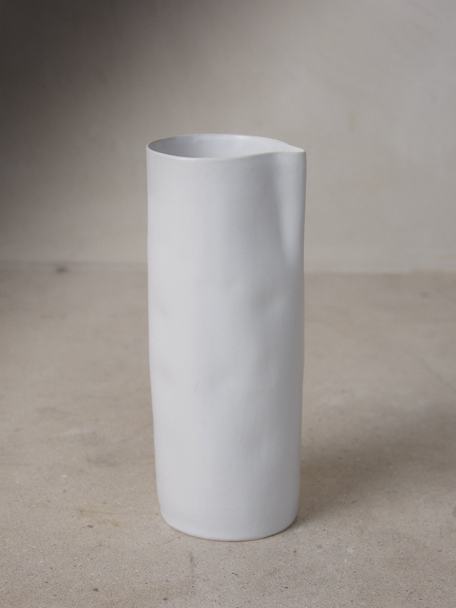 Raw Carafe. Exclusively ours. Designed to fit naturally in the hand, this minimalist, hand-formed carafe recalls the natural world with a perfectly imperfect bodice in versatile matte white stoneware.