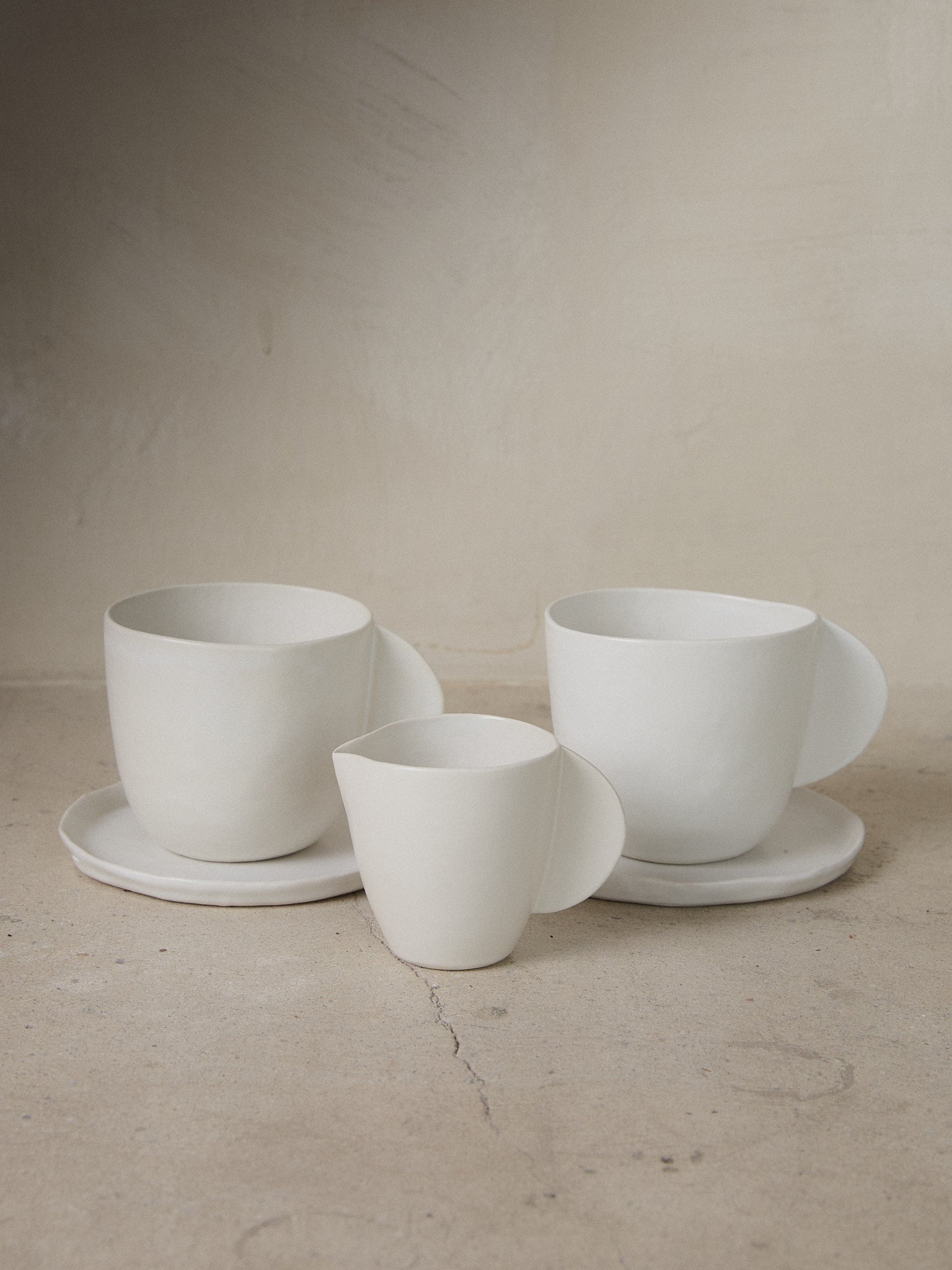 Raw Coffee + Creamer Set. Exclusively ours. Limited edition, minimalist coffee or tea set recalling the natural world with a perfectly imperfect shapes in versatile matte white stoneware. 