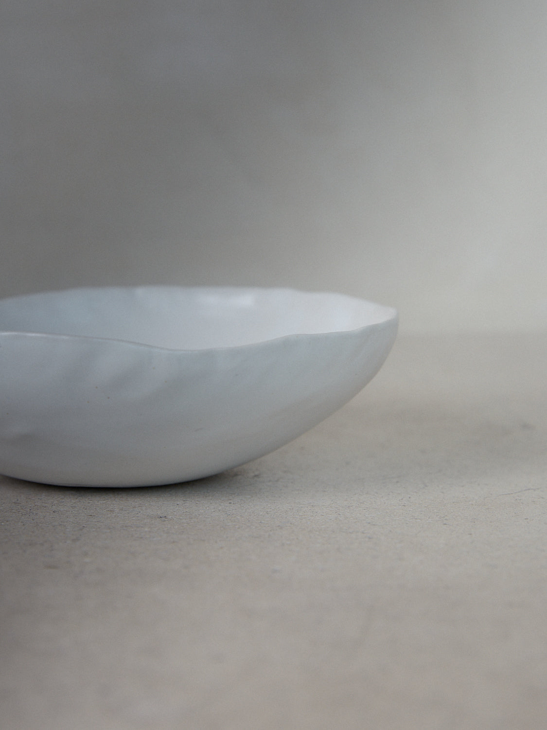 Raw Shallow Bowl in Ecru. Handmade shallow serving bowl perfect for entertaining and everyday use in classic matte white stoneware.