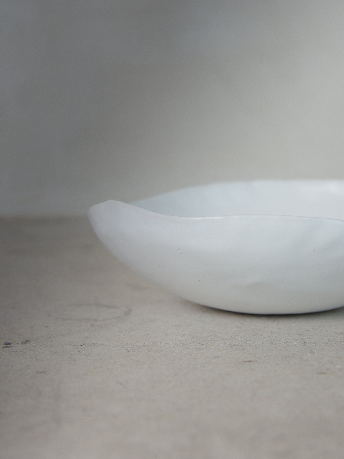 Raw Shallow Bowl in Ecru. Handmade shallow serving bowl perfect for entertaining and everyday use in classic matte white stoneware.