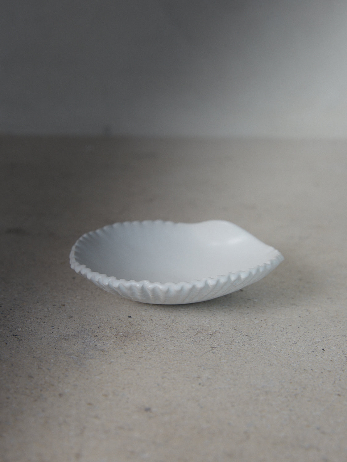 Raw Shell Dish. A hand-formed, stoneware dish recalling the sea in a classic matte white finish. 