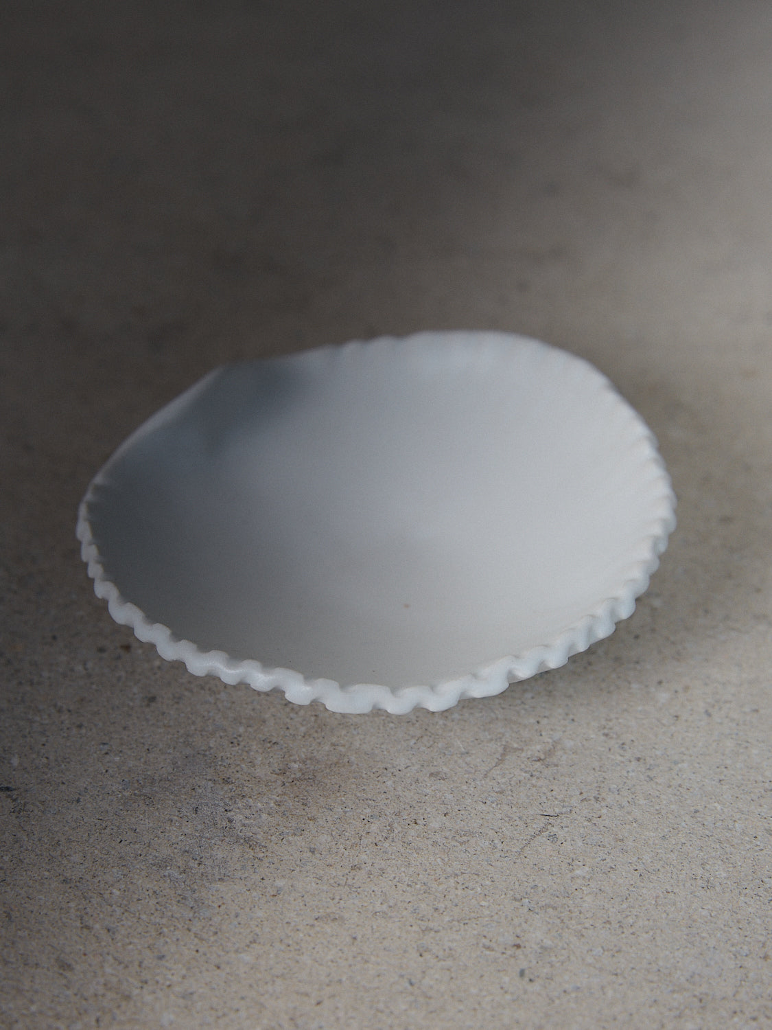Raw Shell Dish. A hand-formed, stoneware dish recalling the sea in a classic matte white finish. 