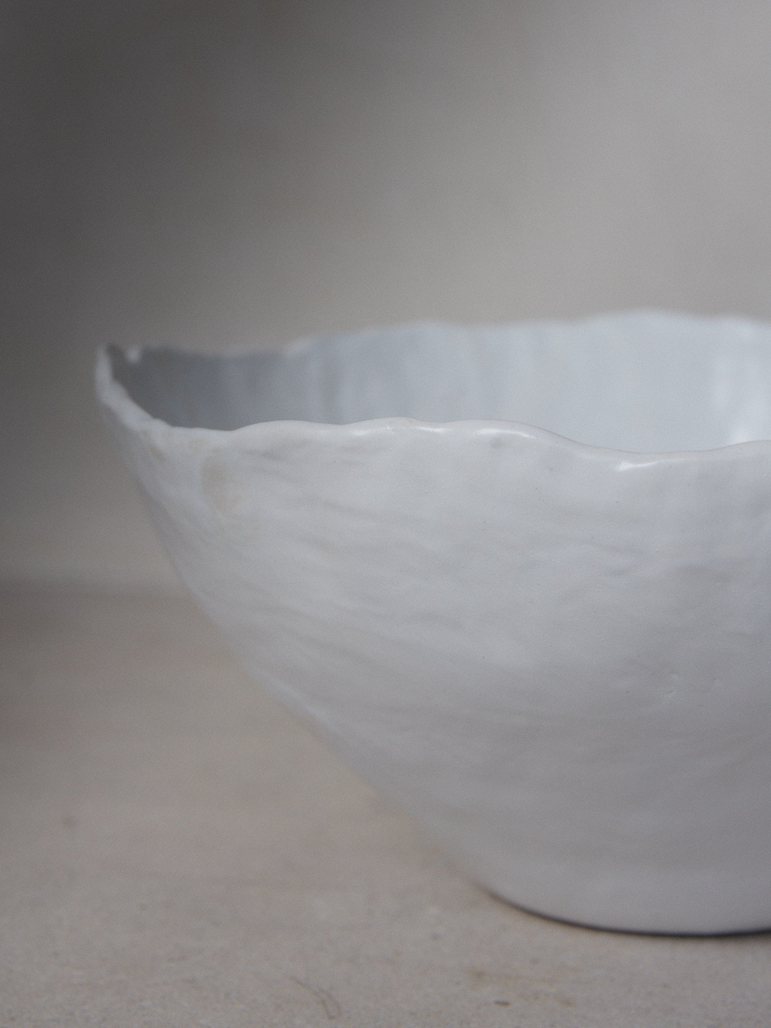 XL Raw Bowl. Exclusively ours. Timelessly elegant, oversize, ceramic bowl with subtly irregular edges revealing the touch of the artist's hand in classic matte white stoneware.