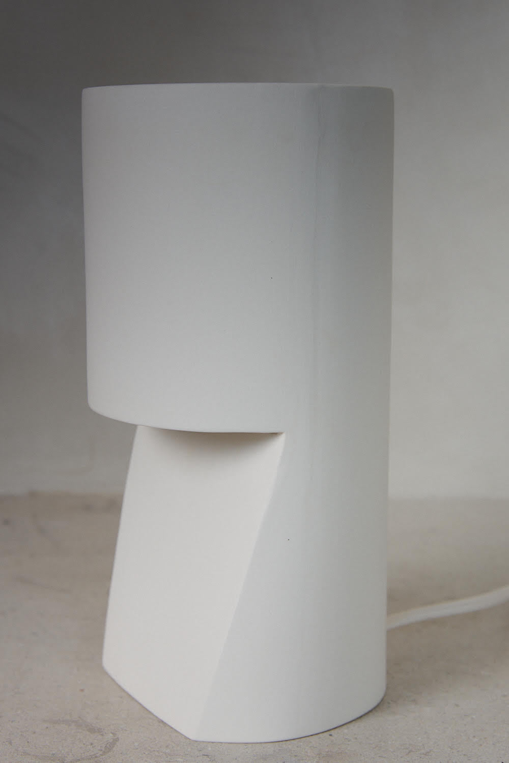 Pillar Light. A cylindrical, hand sanded porcelain pillar table lamp in natural white.